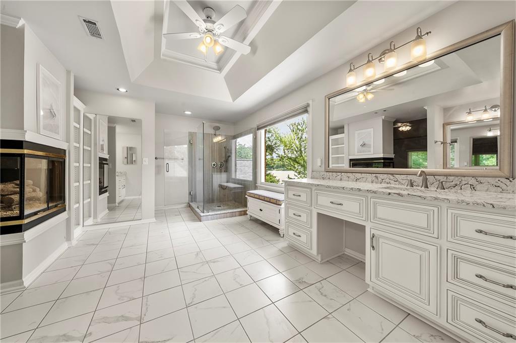 75 Spring Ridge Court Newnan, GA 30265 - Photo 46 of 75 a large white kitchen with a large window and stainless steel appliances