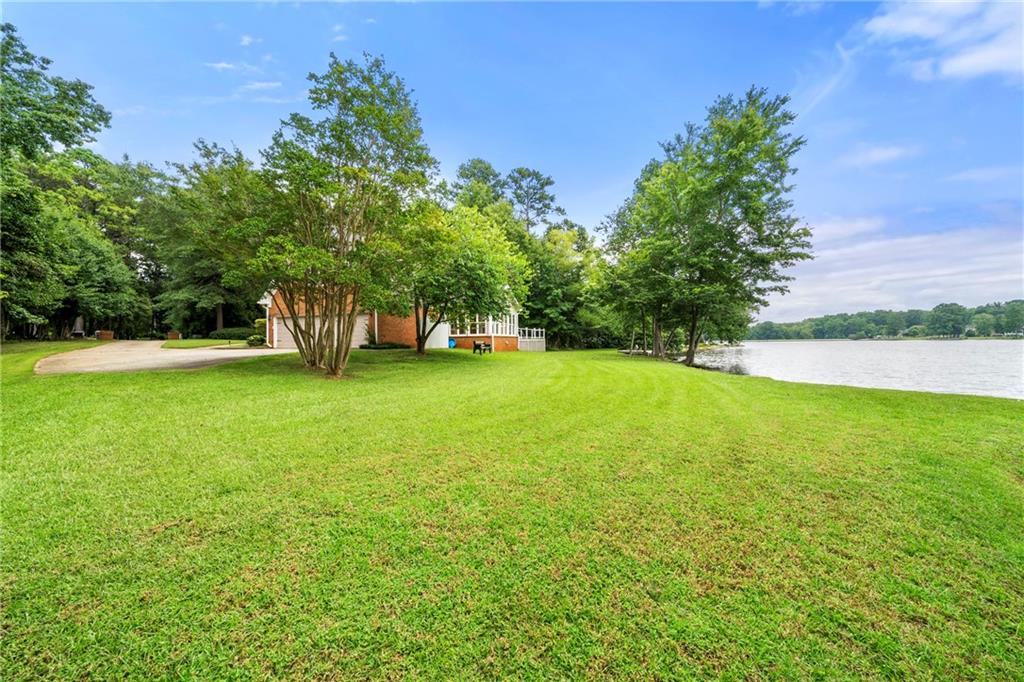 75 Spring Ridge Court Newnan, GA 30265 - Photo 66 of 75 a view of yard with swimming pool and trees in the background