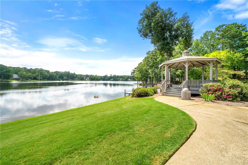 75 Spring Ridge Court Newnan, GA 30265 - Photo 71 of 75 a view of a patio with a table and chairs under an umbrella