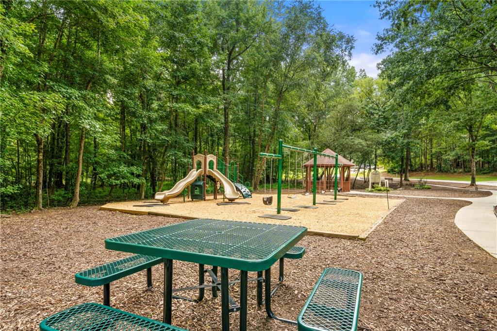 75 Spring Ridge Court Newnan, GA 30265 - Photo 74 of 75 a backyard of a house with barbeque oven table and chairs