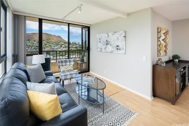 a living room with furniture and a floor to ceiling window
