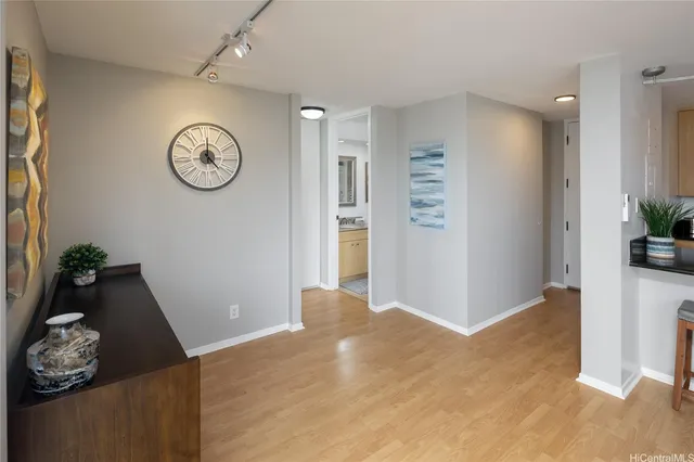 a view of a room with wooden floor and lots of windows
