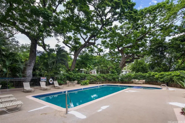 a view of a swimming pool with a yard