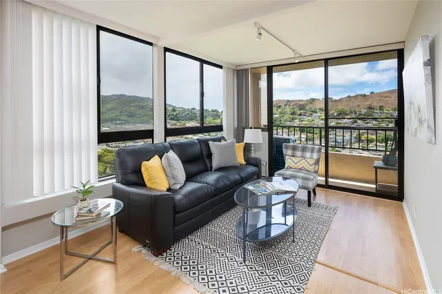 a living room with furniture and a floor to ceiling window
