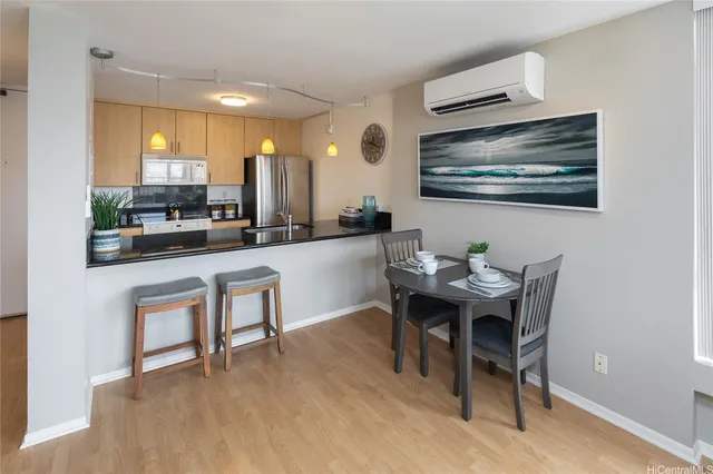 a dining room with furniture and wooden floor