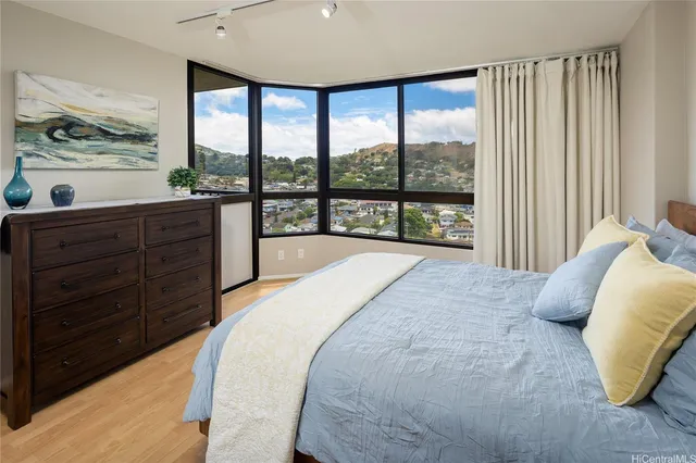 a spacious bedroom with a large bed and a large window