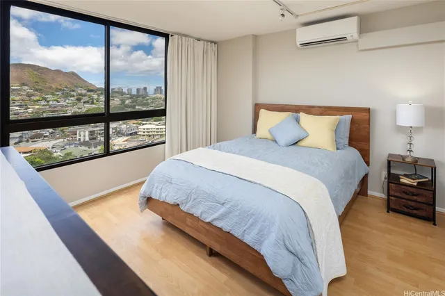 a large bed sitting in a bedroom next to a large window