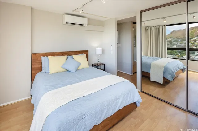 a bedroom with bed and large window