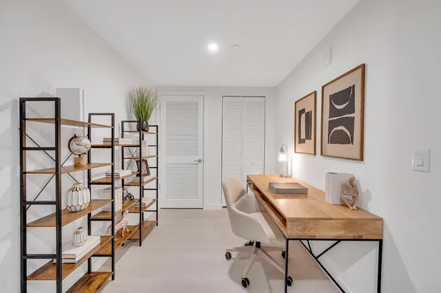 a view of a workspace with furniture and a potted plant