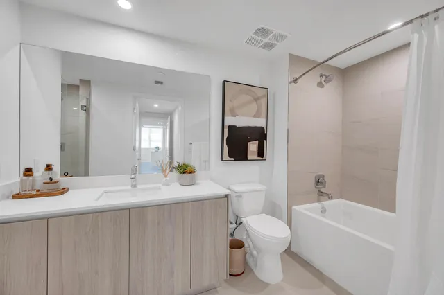 a bathroom with a sink toilet tub and shower