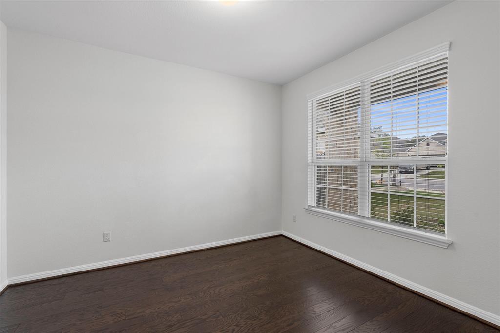 236 Prato Place Georgetown, TX 78628 - Photo 7 of 40 Hardwood floors and generous windows illuminate this versatile bonus room.