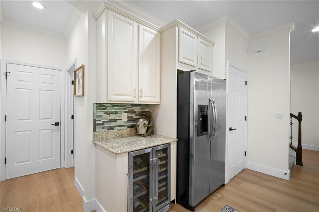 19501 Bowring Park Road, Unit 102 Fort Myers, FL 33967 - Photo 14 of 33 a kitchen with white cabinets and refrigerator