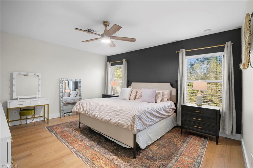 19501 Bowring Park Road, Unit 102 Fort Myers, FL 33967 - Photo 22 of 33 a bedroom with a bed and a ceiling fan