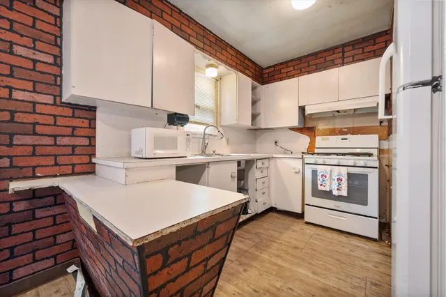 a kitchen with a stove and a refrigerator