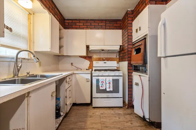 a kitchen with a refrigerator and a sink