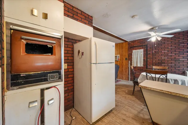 a kitchen with refrigerator a microwave a stove and a refrigerator