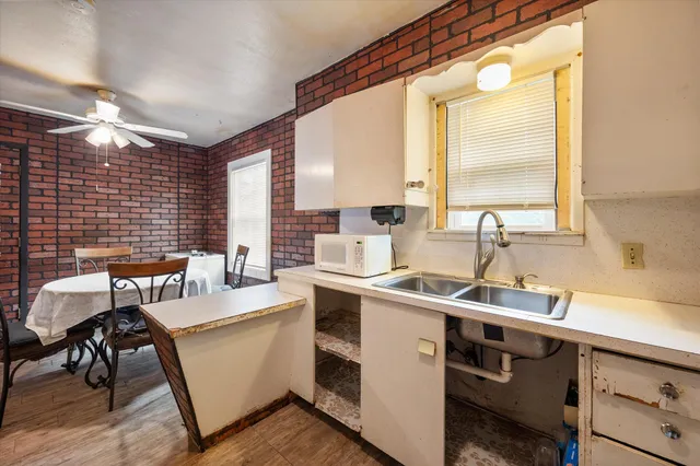 a view of a kitchen with a sink and cabinets