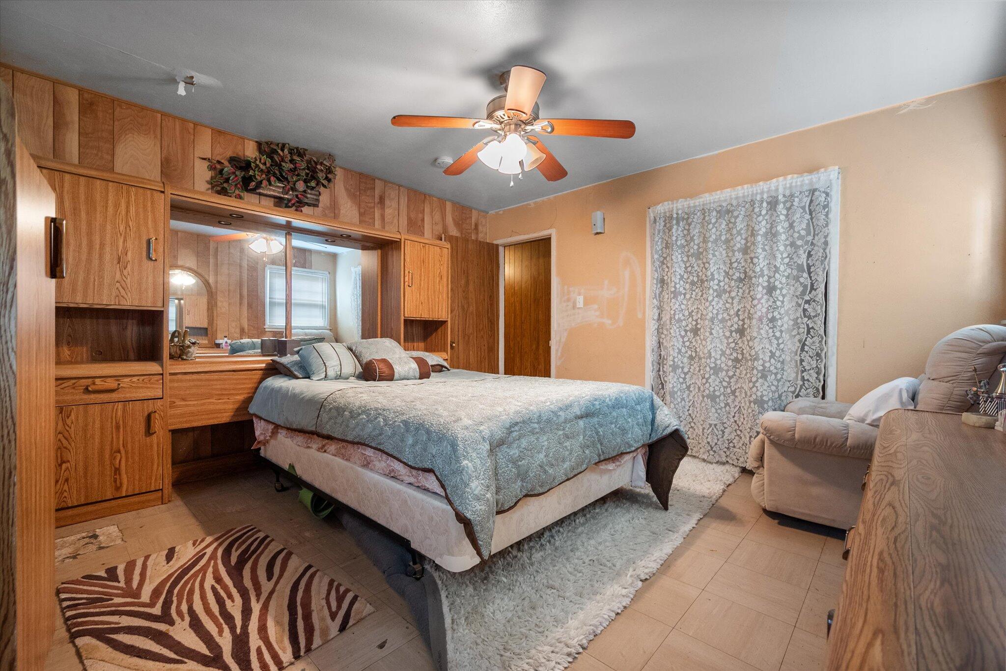 3407 East Colgate Street Lubbock, TX 79403 - Photo 16 of 22 a bedroom with a bed and a chandelier