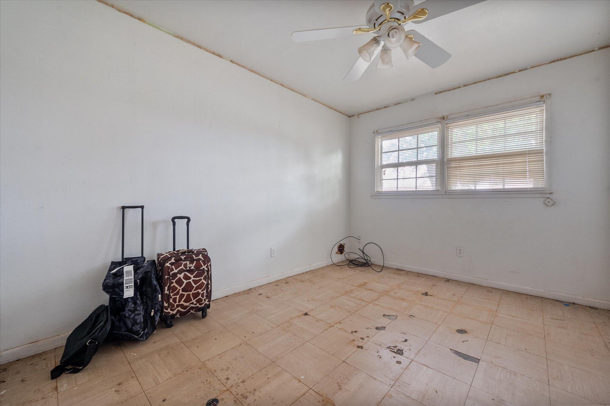 3407 East Colgate Street Lubbock, TX 79403 - Photo 18 of 22 a room with chandelier fan and windows