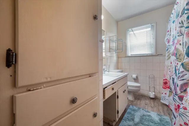 a bathroom with a sink a vanity and a toilet