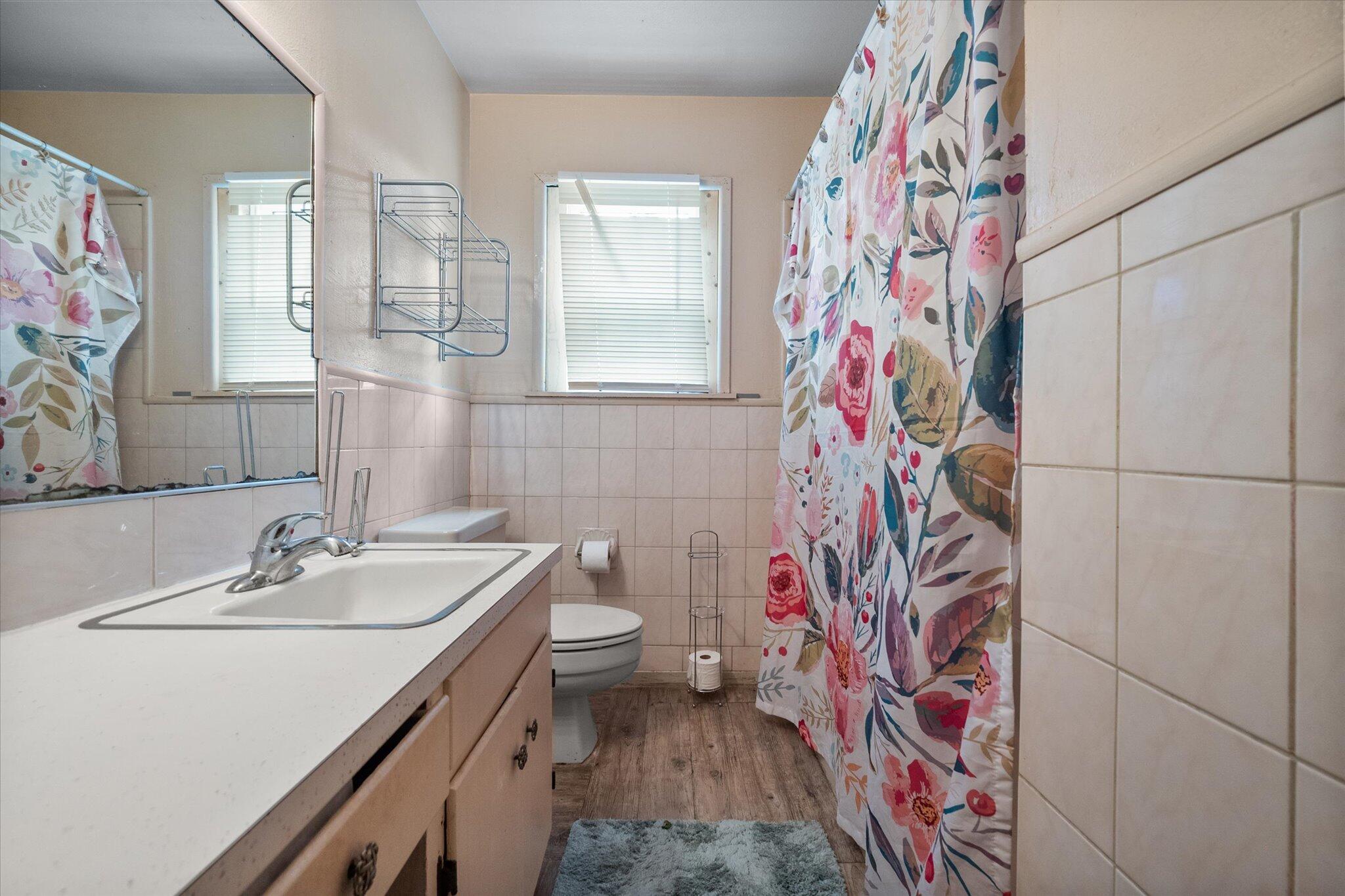 3407 East Colgate Street Lubbock, TX 79403 - Photo 21 of 22 a bathroom with a sink toilet and shower