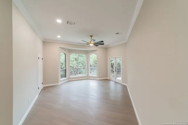 wooden floor in an empty room with a window