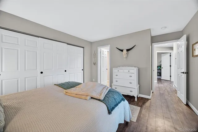 a bedroom with a bed and a flat tv screen