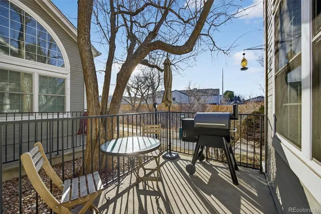 a balcony with table and chairs
