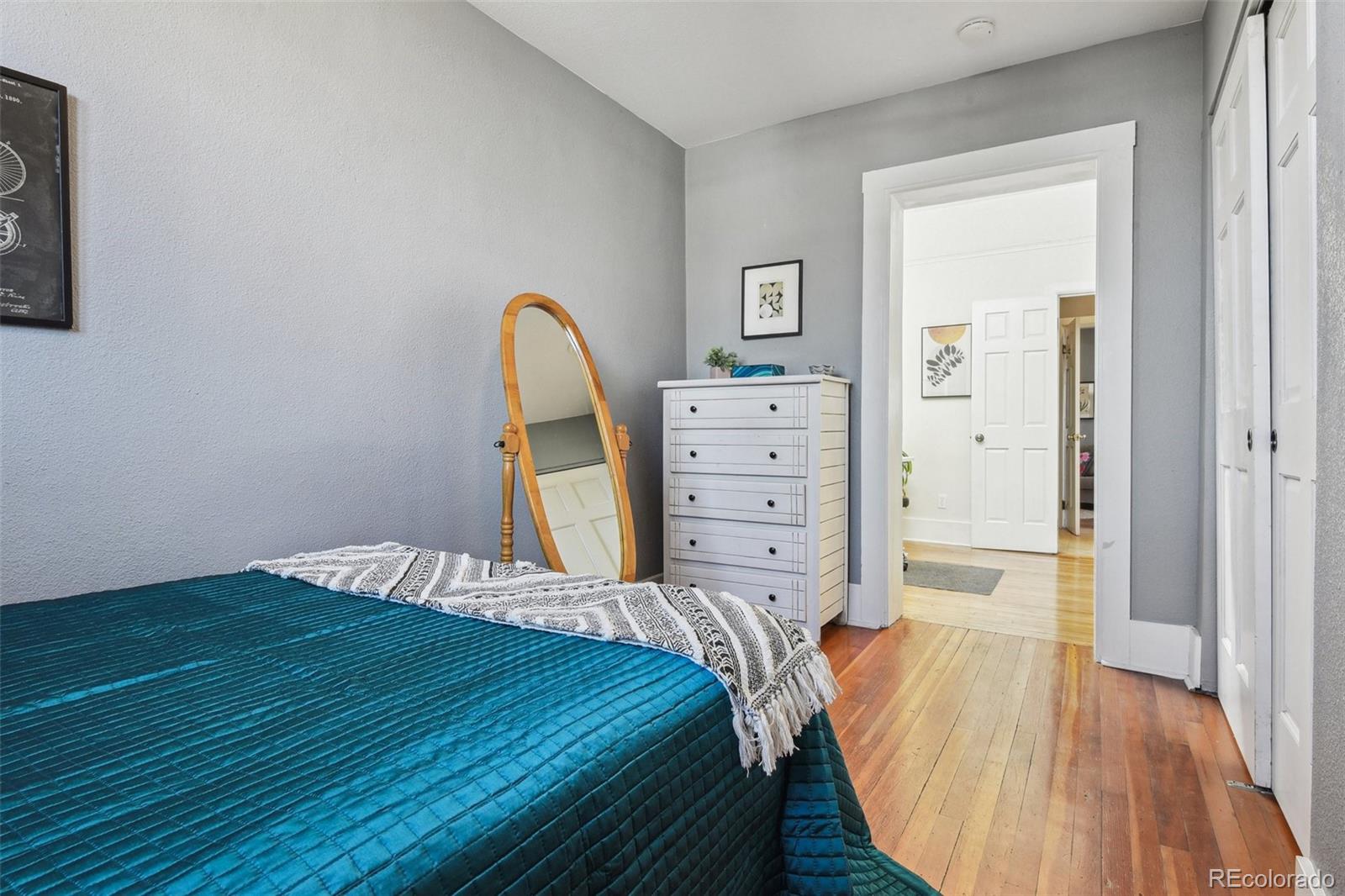 3946 Perry Street Denver, CO 80212 - Photo 13 of 27 a bedroom with a bed and wooden floor