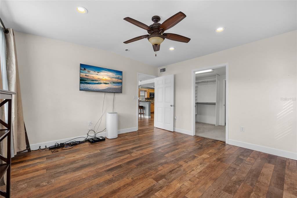 3130 Southwest 86th Way Bell, FL 32619 - Photo 13 of 52 a view of empty room with wooden floor and ceiling fan