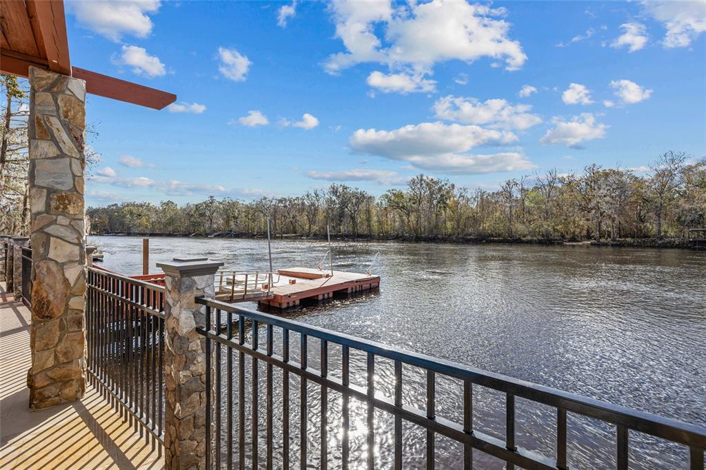 3130 Southwest 86th Way Bell, FL 32619 - Photo 33 of 52 a balcony with wooden floor and lake view