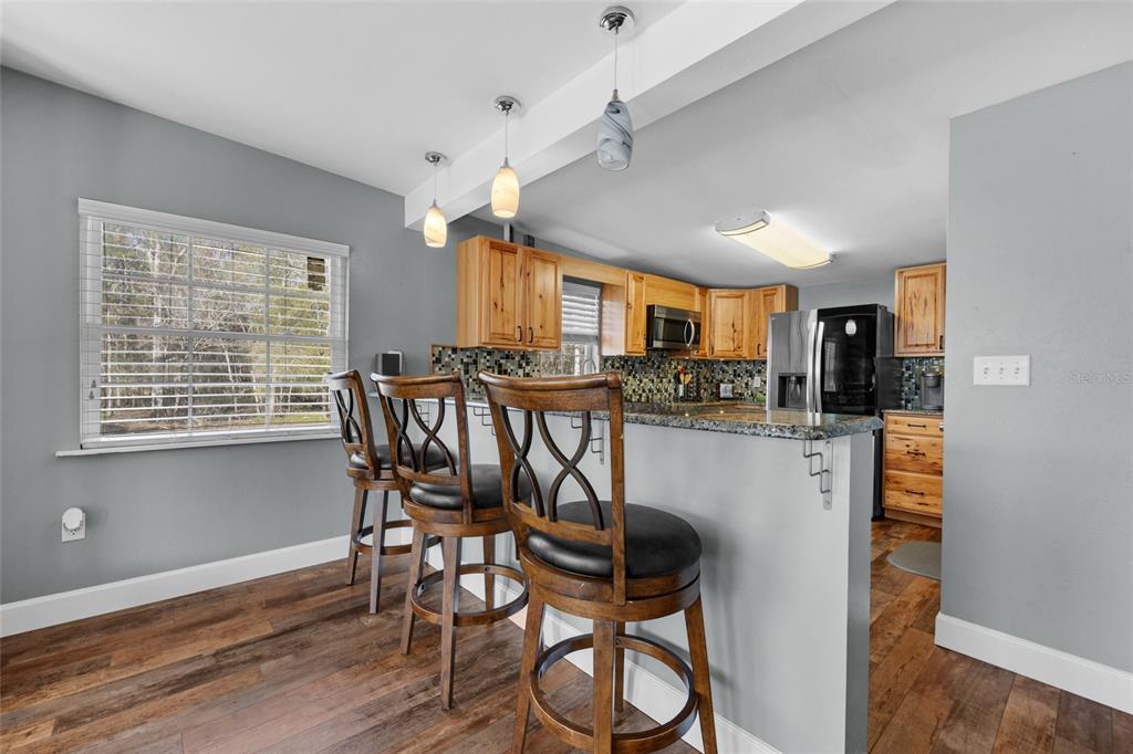 3130 Southwest 86th Way Bell, FL 32619 - Photo 8 of 52 a dining room with furniture and window