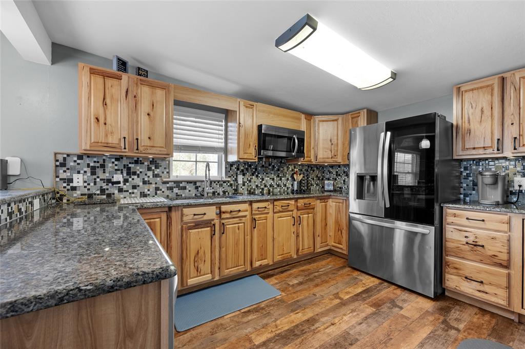 3130 Southwest 86th Way Bell, FL 32619 - Photo 9 of 52 a kitchen with stainless steel appliances granite countertop a sink stove and refrigerator
