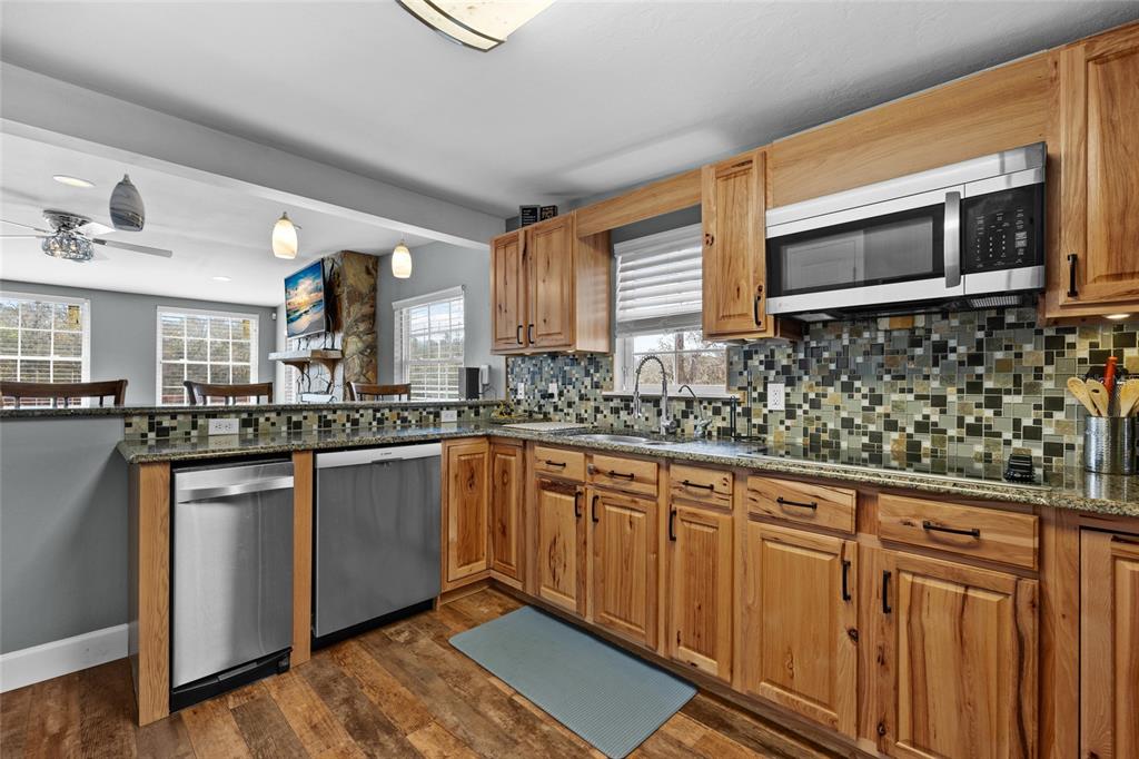 3130 Southwest 86th Way Bell, FL 32619 - Photo 10 of 52 a kitchen with stainless steel appliances granite countertop a sink and a microwave