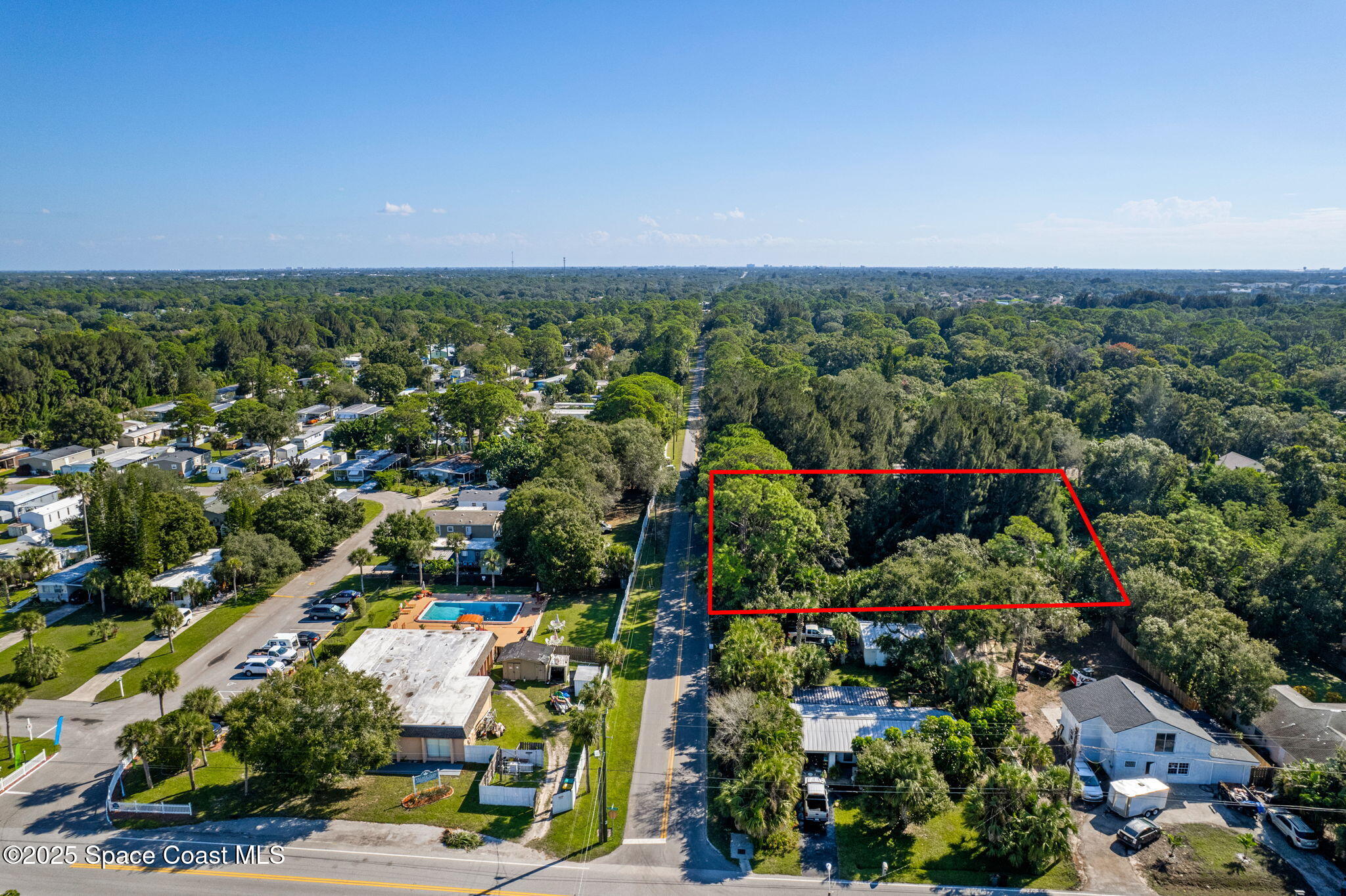 4301 White Road Melbourne, FL 32934 - Photo 2 of 8 an aerial view of a city with lots of residential buildings