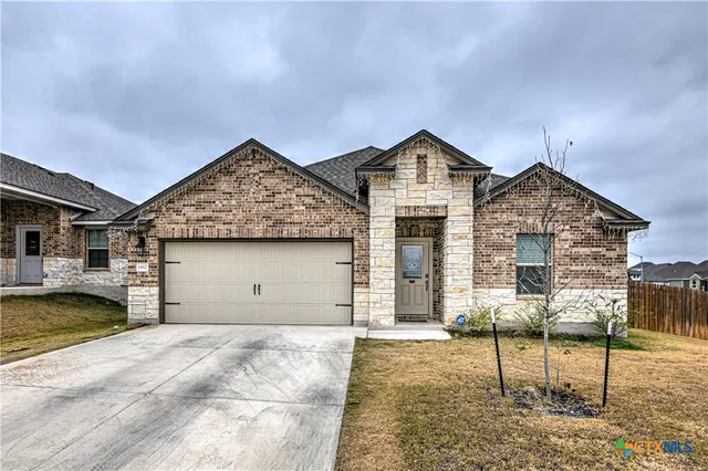 a view of a house with a wooden bench and floor to ceiling window