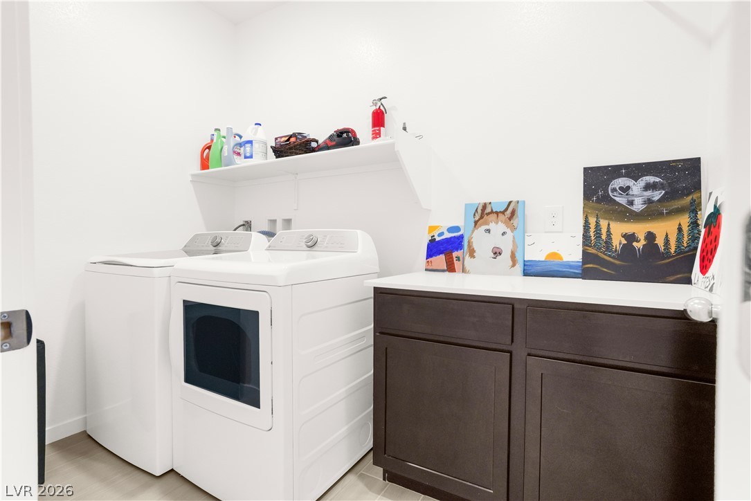 9398 Noble Fir Rdg Court Las Vegas, NV 89143 - Photo 19 of 36 Functional laundry space featuring convenient shelving and practical counter space for everyday tasks.
