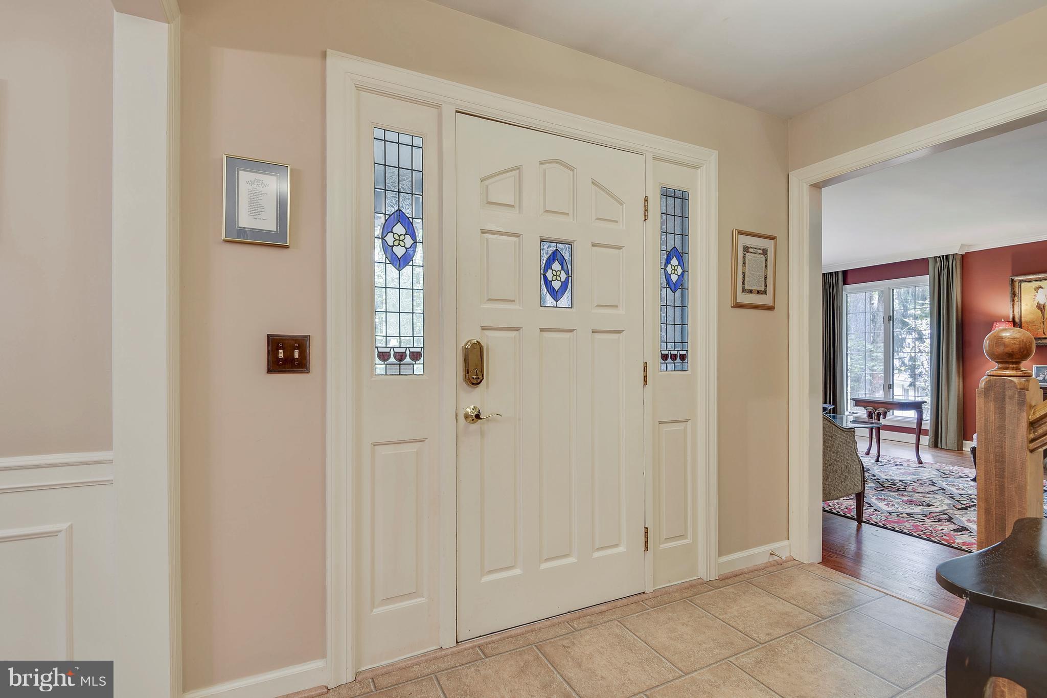 Tile foyer with guest closet