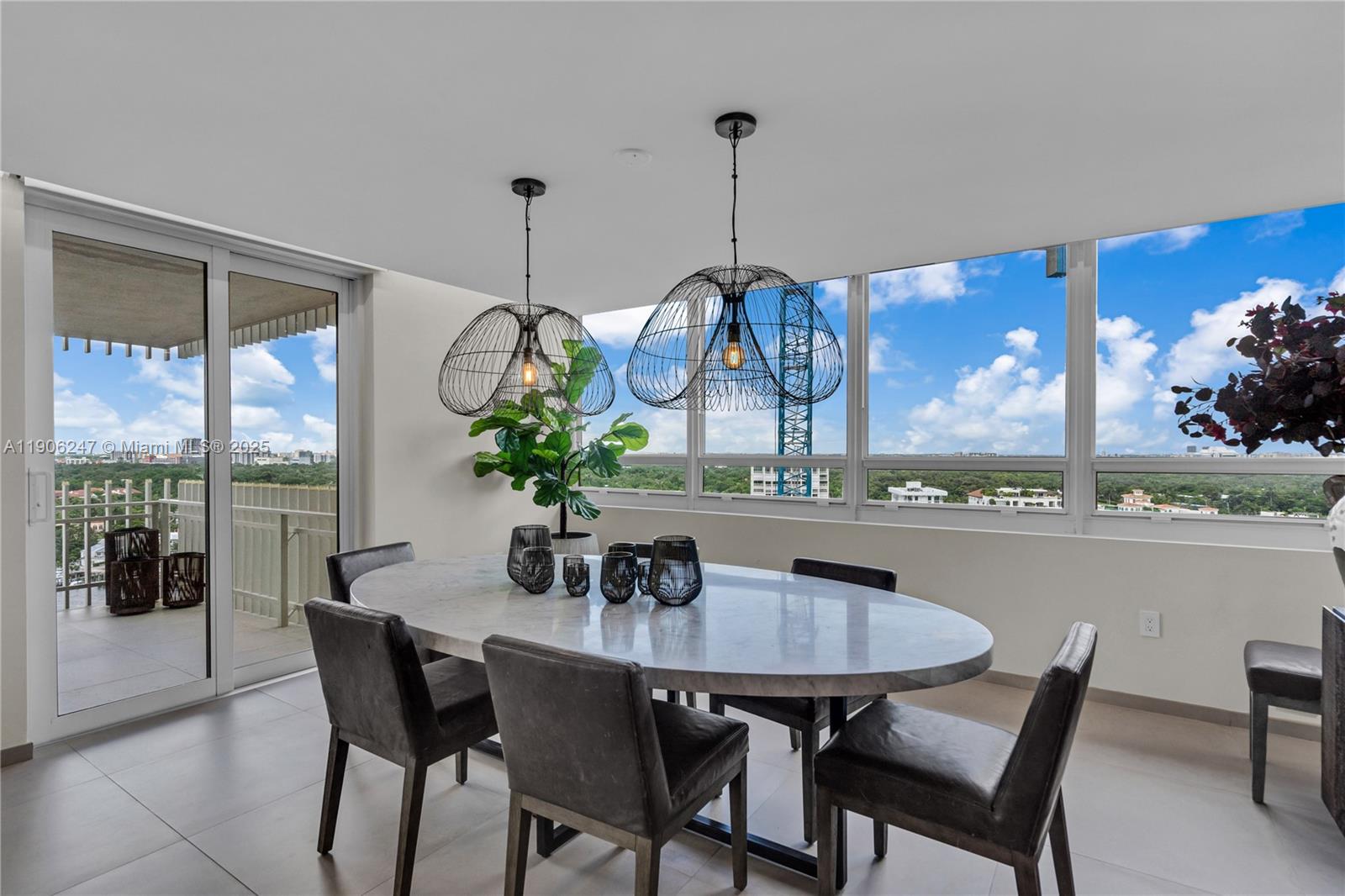 3 Grove Isle Drive, Unit C1710 Miami, FL 33133 - Photo 15 of 37 a dining room table with chairs and potted plants