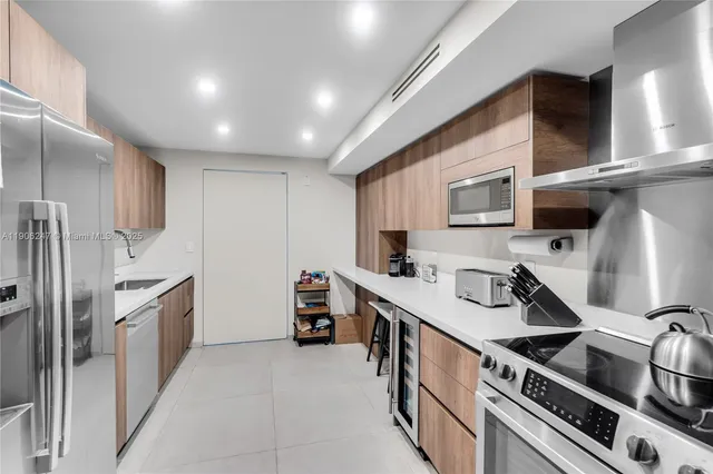 a kitchen with stainless steel appliances a sink stove and cabinets