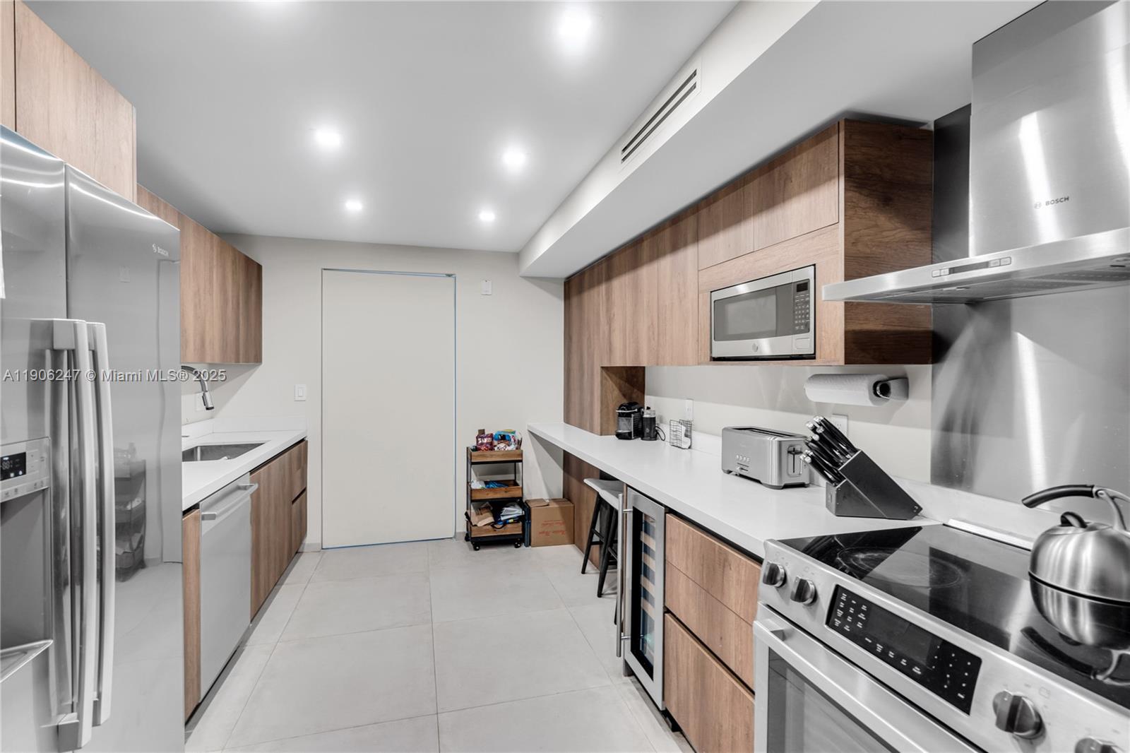 3 Grove Isle Drive, Unit C1710 Miami, FL 33133 - Photo 17 of 37 a kitchen with stainless steel appliances a sink stove and cabinets
