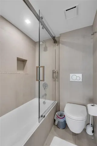 a bathroom with a toilet a sink and a shower