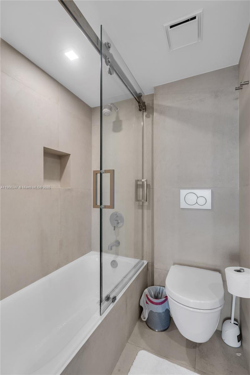 3 Grove Isle Drive, Unit C1710 Miami, FL 33133 - Photo 25 of 37 a bathroom with a toilet a sink and a shower