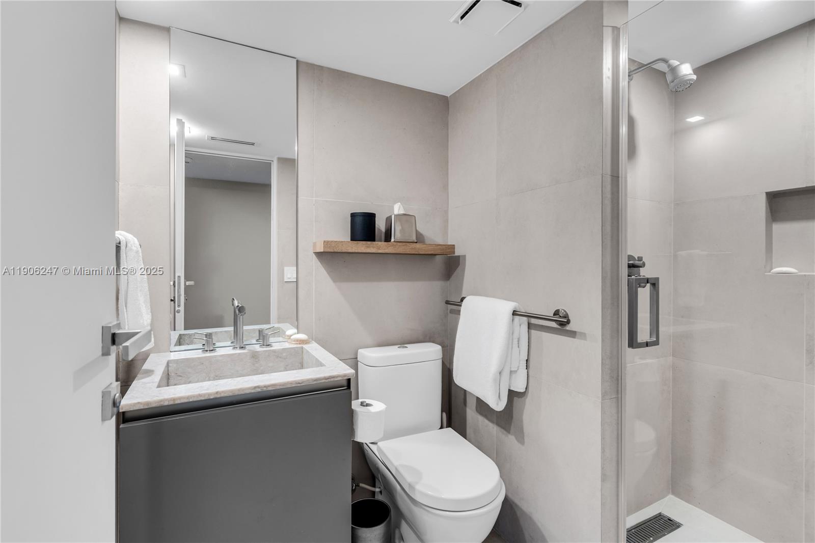 3 Grove Isle Drive, Unit C1710 Miami, FL 33133 - Photo 27 of 37 a bathroom with a toilet sink and mirror