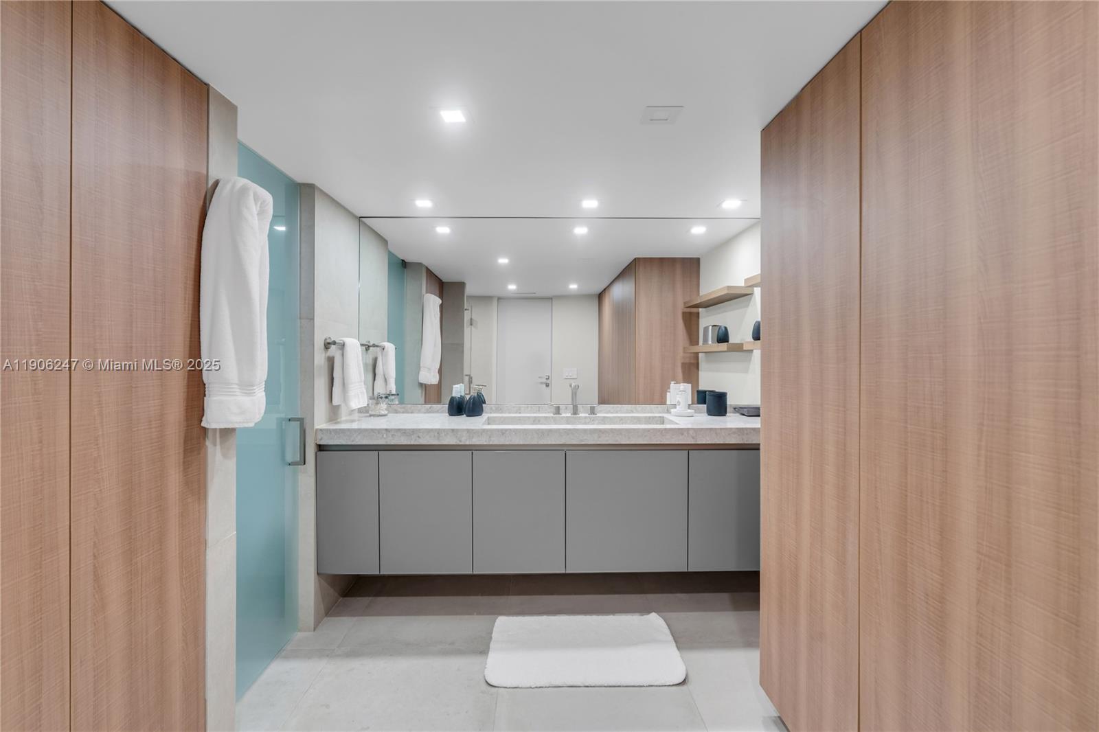 3 Grove Isle Drive, Unit C1710 Miami, FL 33133 - Photo 4 of 37 a bathroom with a sink a mirror and a toilet