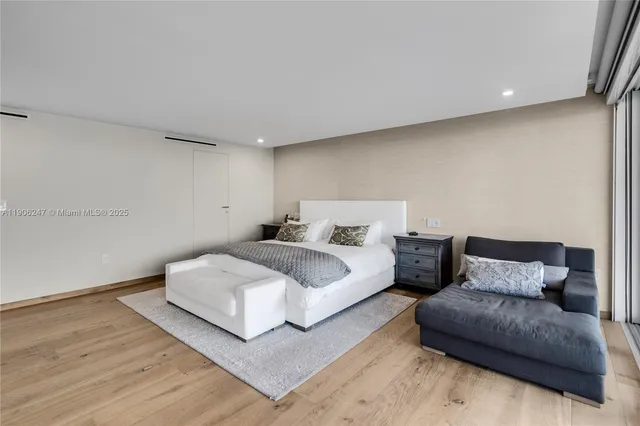 a spacious bedroom with a bed and a couch