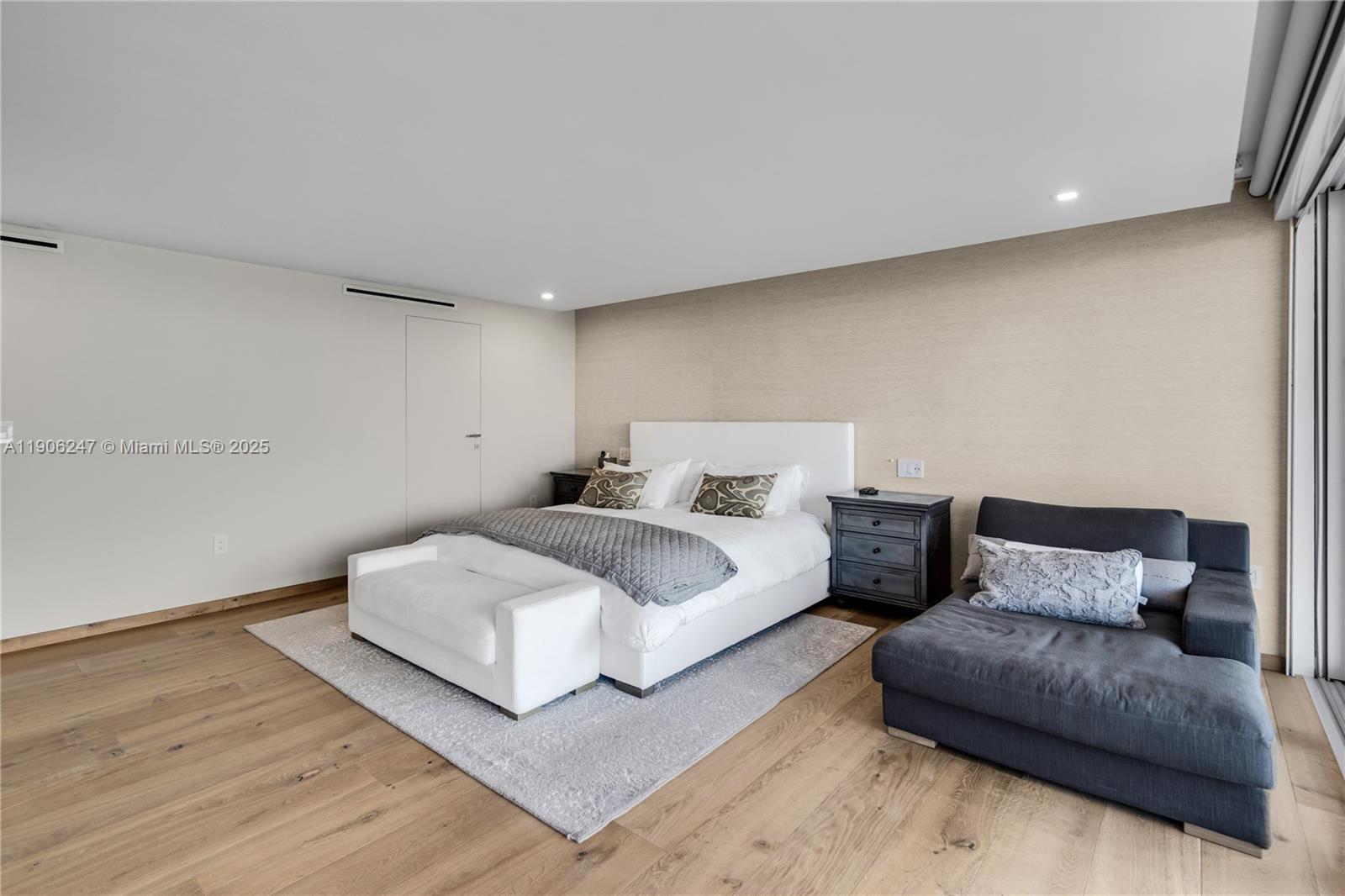 3 Grove Isle Drive, Unit C1710 Miami, FL 33133 - Photo 6 of 37 a spacious bedroom with a bed and a couch