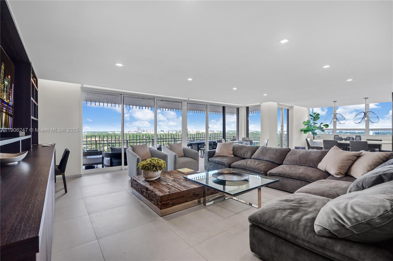 3 Grove Isle Drive, Unit C1710 Miami, FL 33133 - Photo 8 of 37 a living room with furniture and a large window