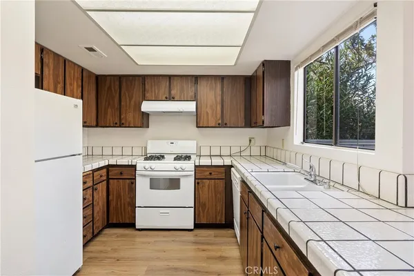 a kitchen with a stove a sink and a refrigerator