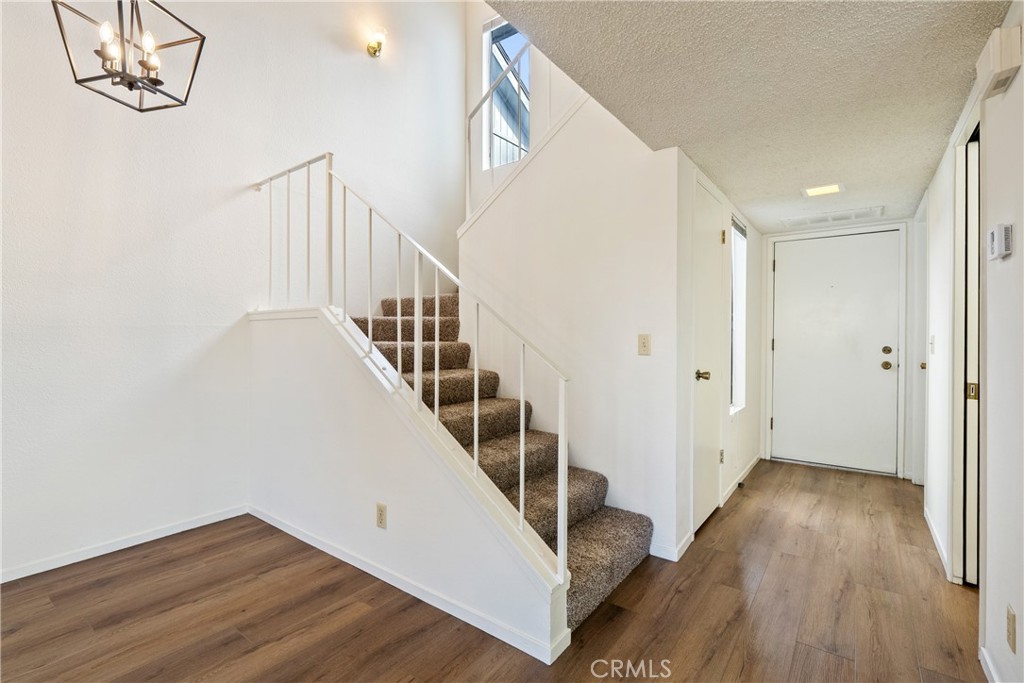 7 Quail Ridge Drive Atascadero, CA 93422 - Photo 15 of 29 a view of a hallway with wooden floor and staircase